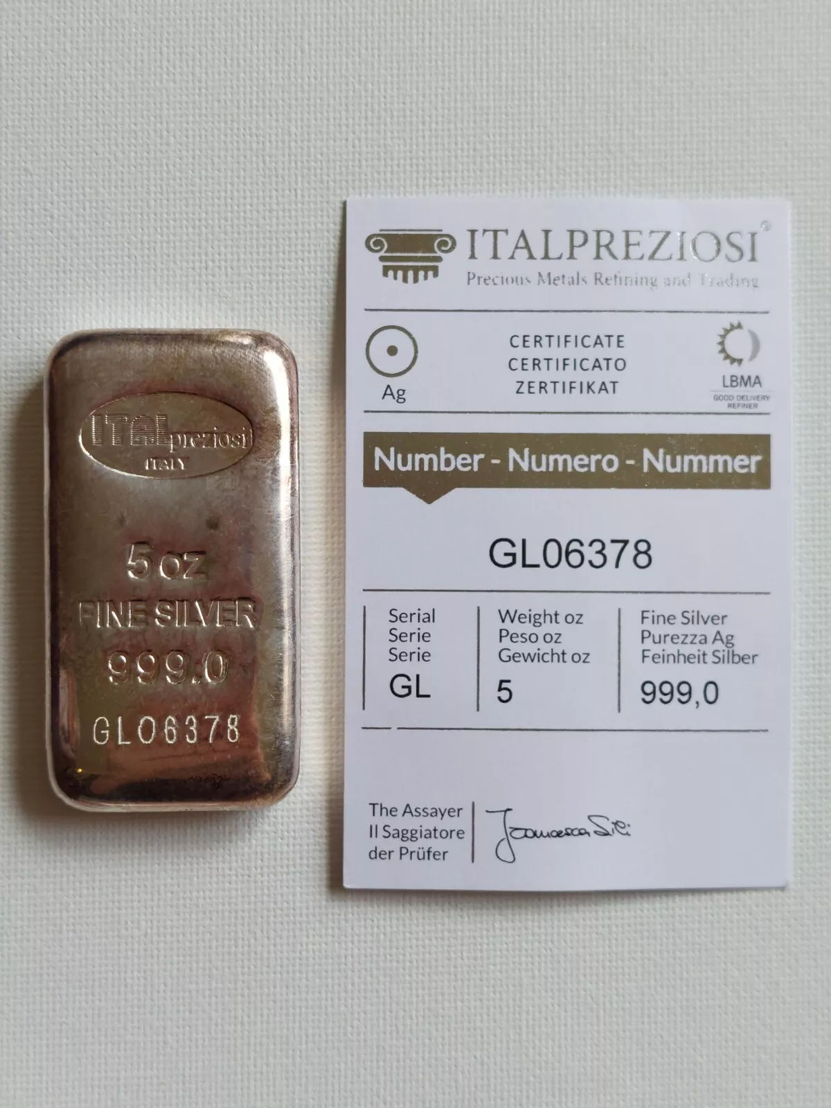 https://static.bullionmatch.com/royalty-precious-metals--5-oz-Silver-Bar-Italpreziosi_with-mint-Essay.webp